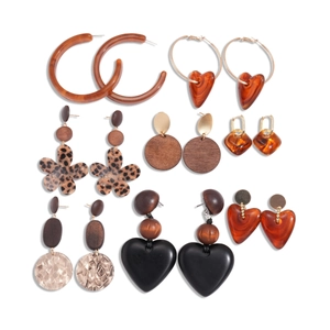 Set of retro acrylic and wood earrings in amber, brown, and gold floral hoop designs