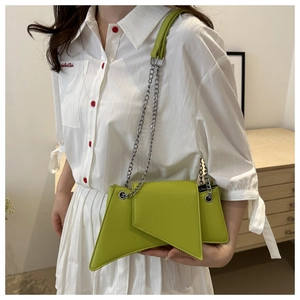 Neon green geometric shoulder bag with silver chain strap worn with white striped shirt