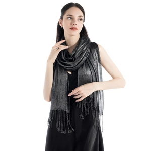 Macro shot of black scarf fringe with shimmering silver thread and tassels detail
