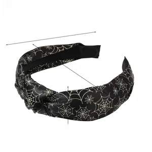 Detail of knotted spider web pattern headband showing dimensions 16cm x 12cm and 3cm width