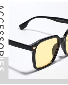 Macro detail of high-quality black frame sunglasses with yellow lenses and metal hinge