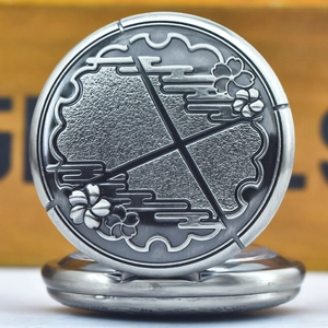 Detail of silver vintage pocket watch cover with embossed cherry blossom pattern