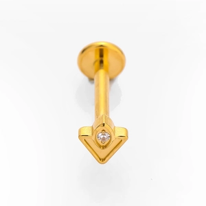 Macro shot of gold G23 titanium labret with triangular clear cubic zirconia gem