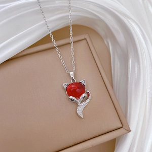 Close-up of red fox pendant necklace featuring sparkling crystals on silver-tone chain