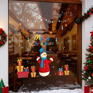 Merry Christmas snowman window stickers on a glass door with festive decorations