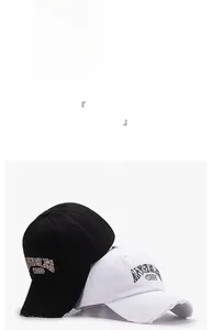 Detail of cotton baseball caps with 1994 embroidery and distressed brim in three colors