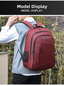 Detail view of burgundy oxford backpack with multiple zip compartments and mesh side pockets