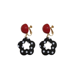 Ohrclips mit gepunkteten Blumen und roten Halbkugeln im trendigen Pop-Stil Design