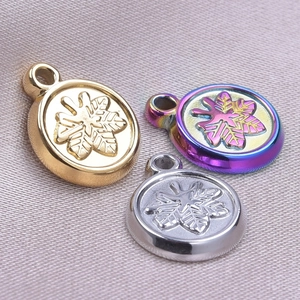 Detail of round stainless steel pendants in gold, silver, and rainbow snowflake designs