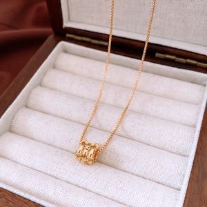 Detailed close-up of 18k gold plated H-shaped pendant necklace with diamond accents