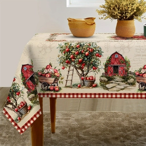 Close-up of rustic tablecloth featuring red barn, apple trees and red-white checkered edges