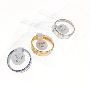 Detail of Roman numeral stainless steel rings in gold, silver and dark grey finishes