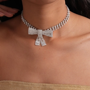 Close-up of luxury double-row bow choker necklace with sparkling rhinestones on model