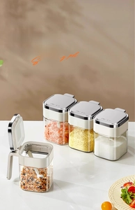 Macro detail of clear kitchen spice jar set with silver lids and moisture-proof seals