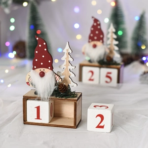 Close-up of wooden Christmas calendar featuring a gnome with red hat and pine cone decor