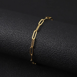 Detail of 18K gold plated stainless steel paperclip chain on a black textured stand