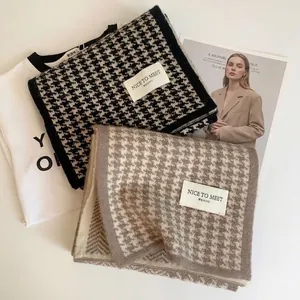 Classic houndstooth knit scarves in black and coffee brown on a clean minimalist layout