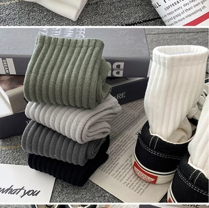 Detailed texture of cotton ribbed athletic crew socks in multiple neutral colors