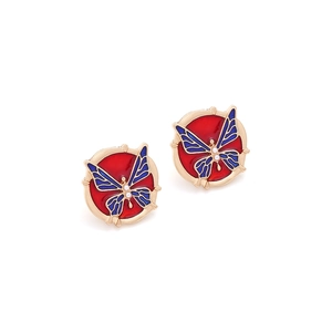 Detail of gold enamel butterfly earrings with red inlay and faux pearl accents
