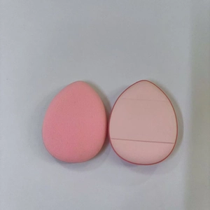 Detailed close-up of pink makeup sponges in teardrop and slanted cut shapes