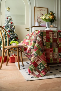 Detail of Christmas tablecloth with woven reindeer and snowflake patterns in festive scene