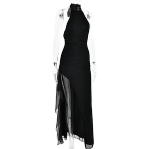 Detail of sexy black halter evening dress with high side slit and sheer mesh insert