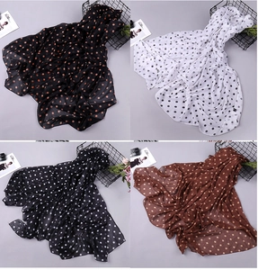Detailed view of lightweight polka dot chiffon scarves in four different color combinations