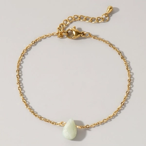 Detail view of gold chain bracelet with teardrop green stone and adjustable clasp