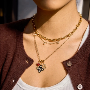 Dreilagige goldene Edelstahlkette mit rotem Herz und schwarzen Blumenanhängern