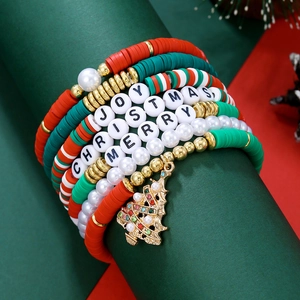 Détail d'un set de bracelets de Noël avec perles d'argile et pendentif sapin doré brillant