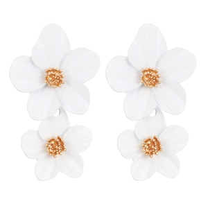 Detail of white resin floral drop earrings with textured gold centers and matte finish