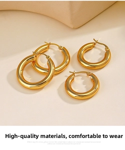 Detail of two sizes of 18K gold plated stainless steel thick hoop earrings with high polish