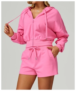 Detail of pink zip-up hoodie showing ribbed cuffs and soft cotton fabric texture