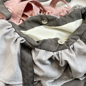 Macro shot of ruffle tote bag with magnetic snap closure and soft suede texture
