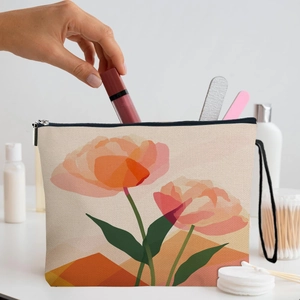 Floral canvas makeup bag with pink tulips and top zipper handle on a vanity