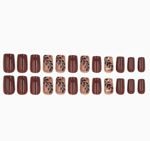 Detailed set of 24 burgundy and nude press-on nails with leaf patterns and gold glitter