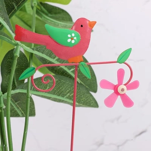 Garden metal decorative stake featuring a colorful pink and green bird with pink flowers