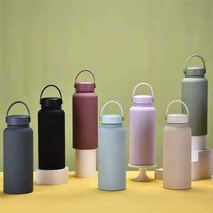 Various Morandi colored stainless steel vacuum insulated bottles on geometric stands