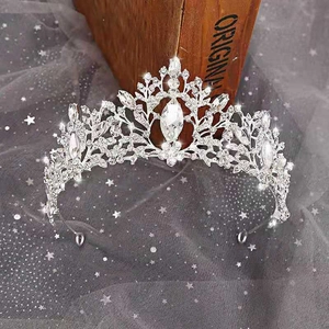 Baroque silver bridal crown with shimmering crystals on a dreamy starlit mesh background