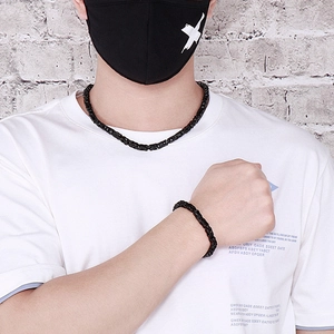 Detail of 6mm black stainless steel Byzantine chain necklace and bracelet set on model
