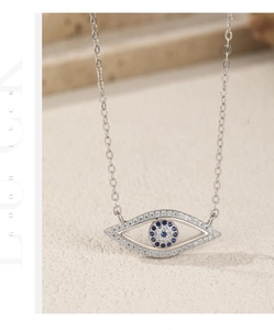 Detailed view of silver Evil Eye necklace with blue zircon and clear stones inlay