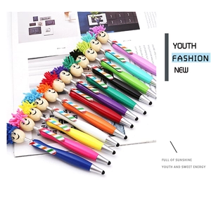 Detail view of colorful plush smiley head pens with dual stylus and ballpoint functions