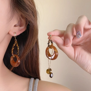 Vintage New Chinese style wooden round pendant earrings detail view on ear and hand