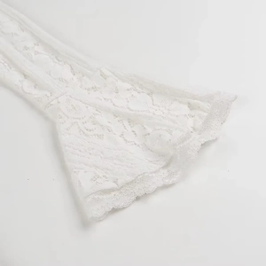 Detailed close-up of white floral lace trumpet sleeves with intricate hollow embroidery