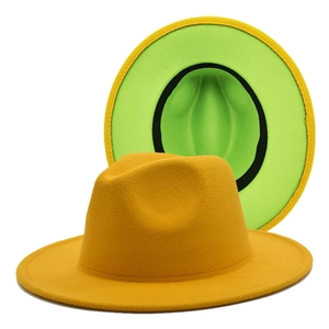 Close-up of stylish wide brim fedora hat in vibrant yellow and green two-tone wool felt