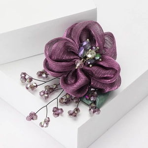 Exquisite purple lace flower brooch with crystal bead tassels on a white background