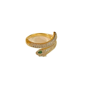 Gold plated snake ring with green zircon eyes and micro-pave white stones on white background
