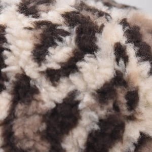 Macro shot of leopard print faux fur material on this warm winter baseball cap