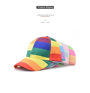 Detail shot of stacked colorful rainbow striped cotton baseball caps with curved brims
