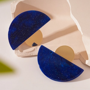 Minimalist geometric acrylic stud earrings with blue starry texture and gold accents